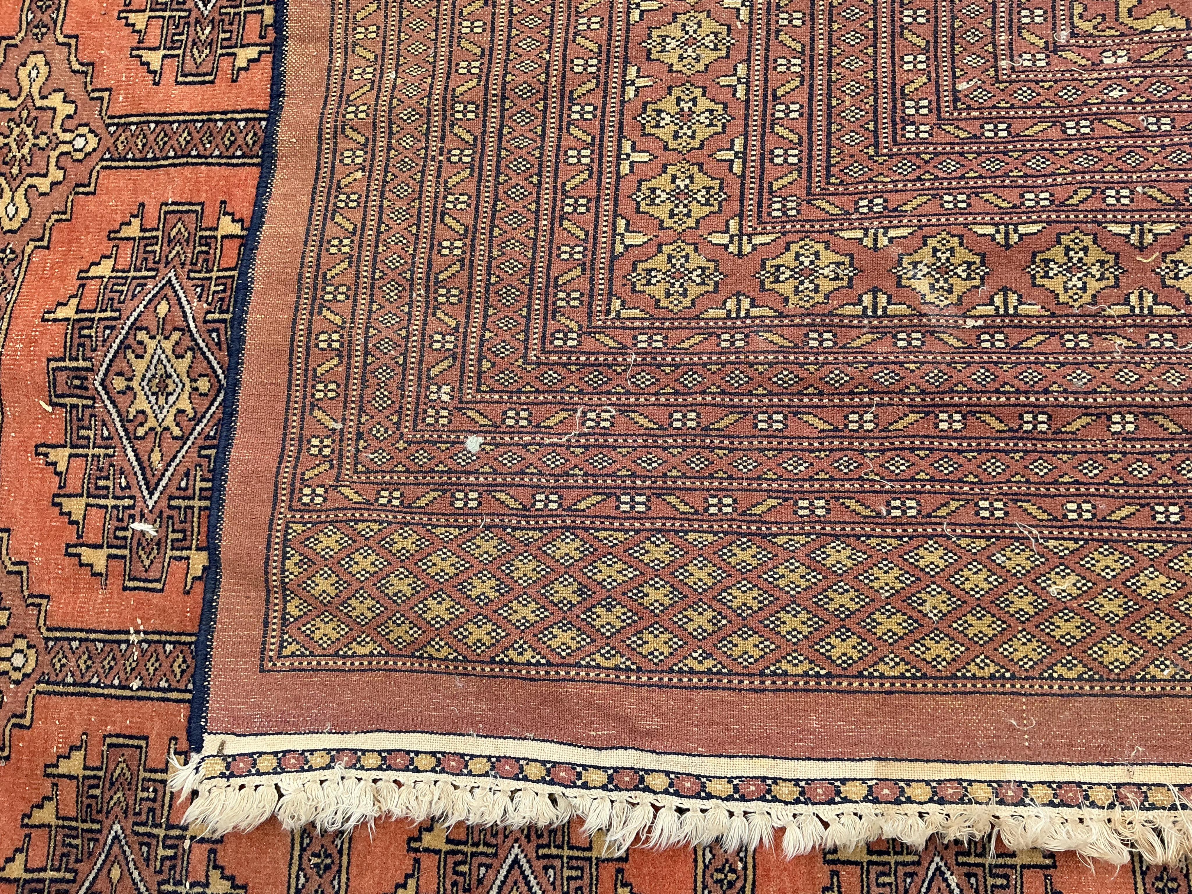 A Bokhara peach ground carpet, 340 x 260cm
